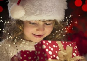 Enfant qui ouvre un cadeau de noel