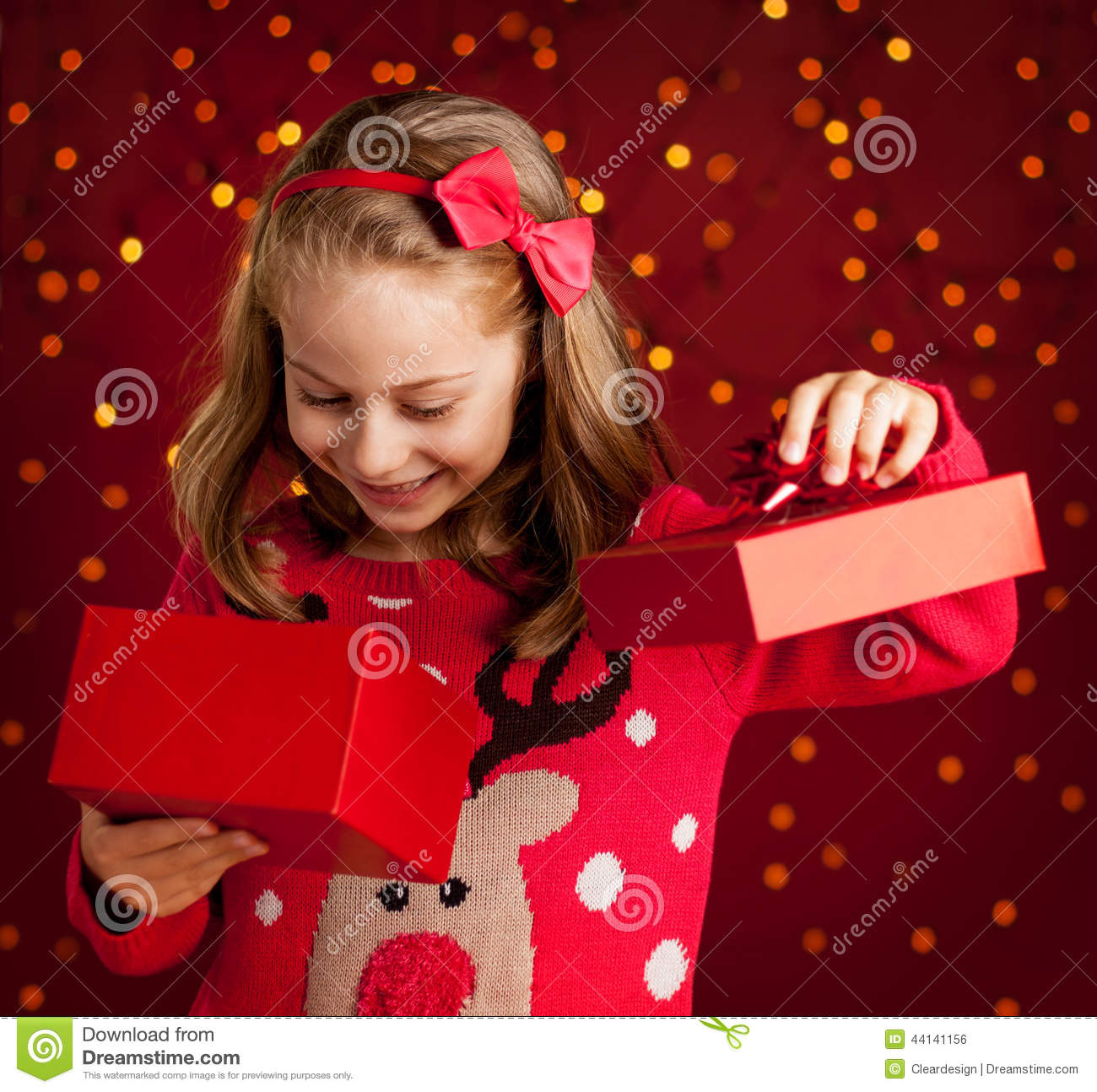 Enfant qui ouvre un cadeau de noel